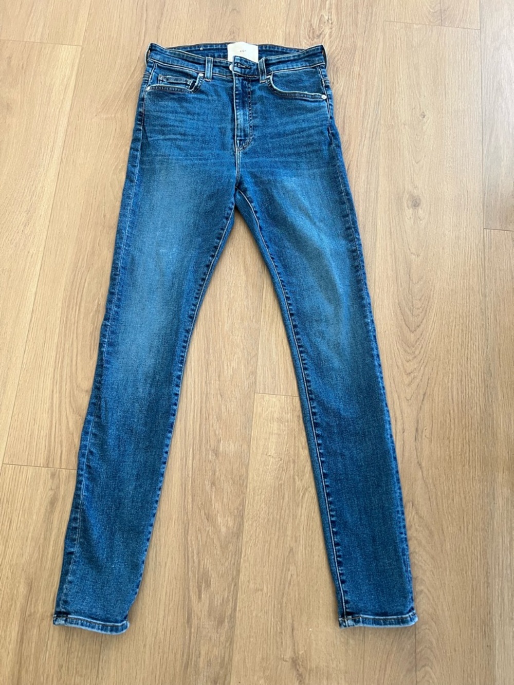 CQY Classic High-Rise Skinny Jeans in Medium Wash Blue. Stretch Size  28